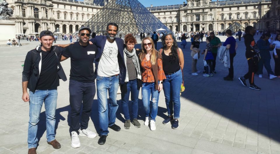 Louvre Pyramid with walkers Louvre Pyramid with walkers
